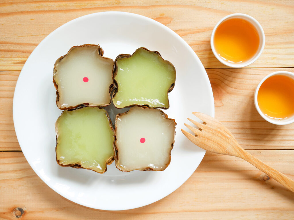 Nian gao, nin gou or Chinese New Year's cake (rice cake) made from glutinous rice flour served with cups of tea