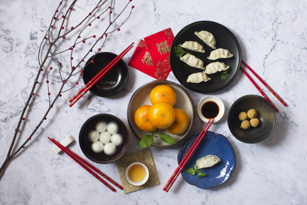 Flat lay Chinese new year food and drink reunion dinner on marble table top background.
