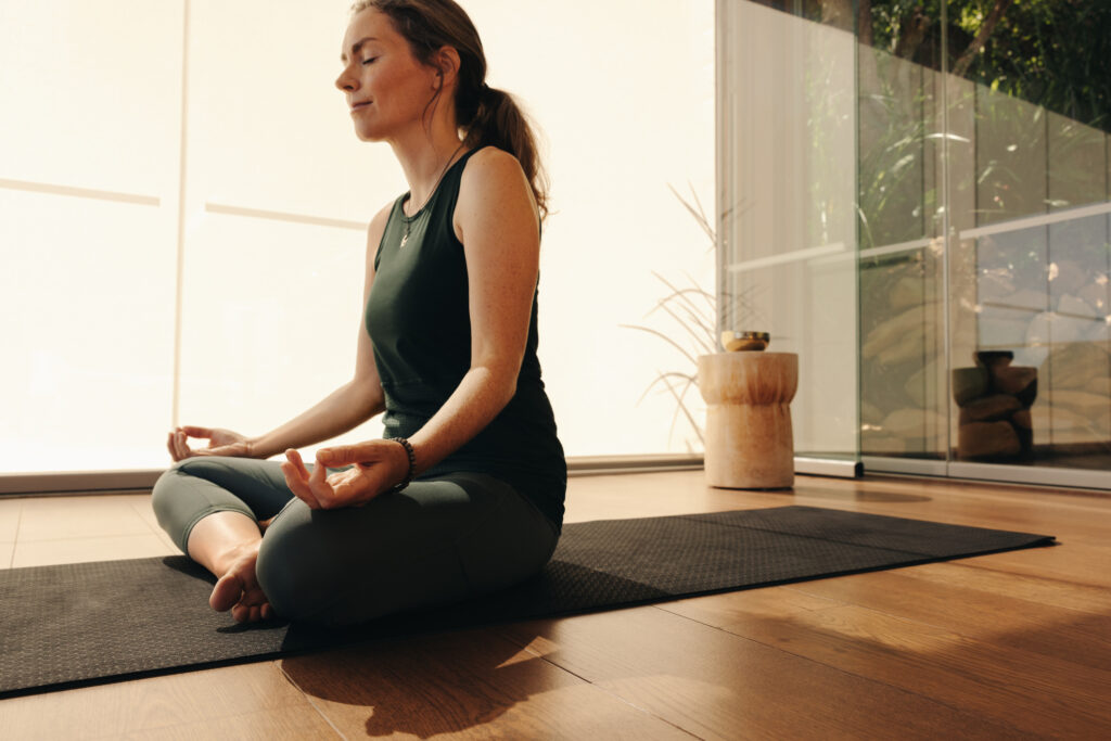 Woman meditating while practicing hatha yoga.